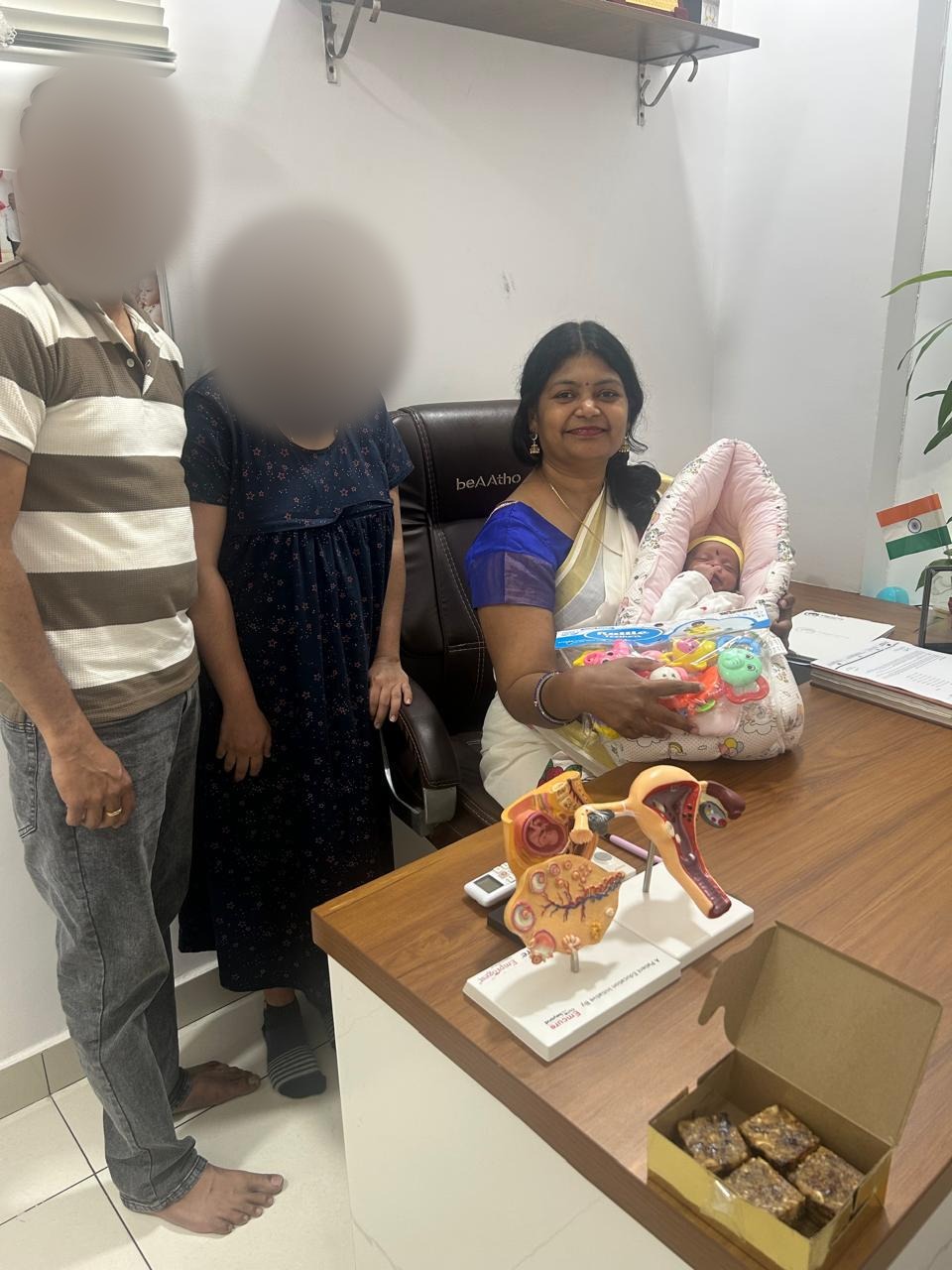 A family with Dr. Mamtha C.V. and their newborn baby at the clinic