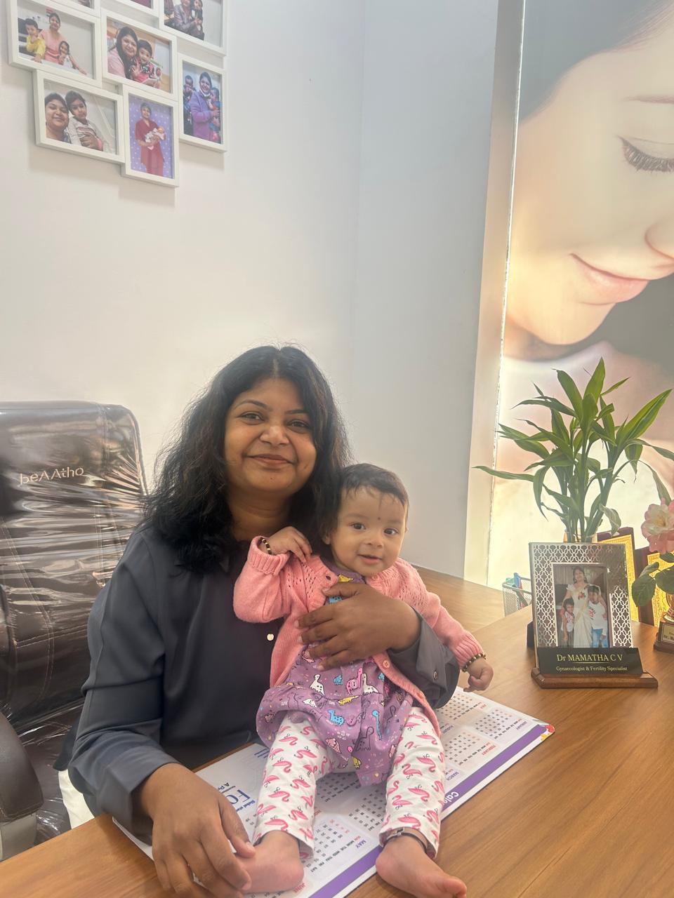 Dr. Mamtha C.V. holding a smiling baby